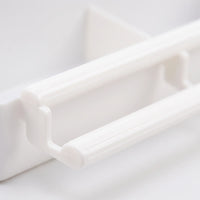 Close-up of the feeder's two ribbed white plastic perch bars and their connecting bracket on the front of the tray. 3