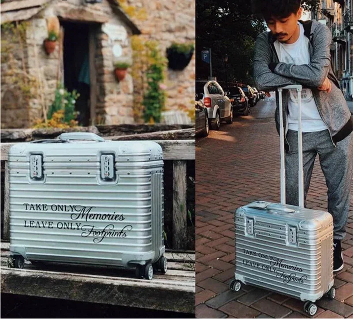Silver case with a printed slogan on a wooden bench, and a man leaning on its handle 2