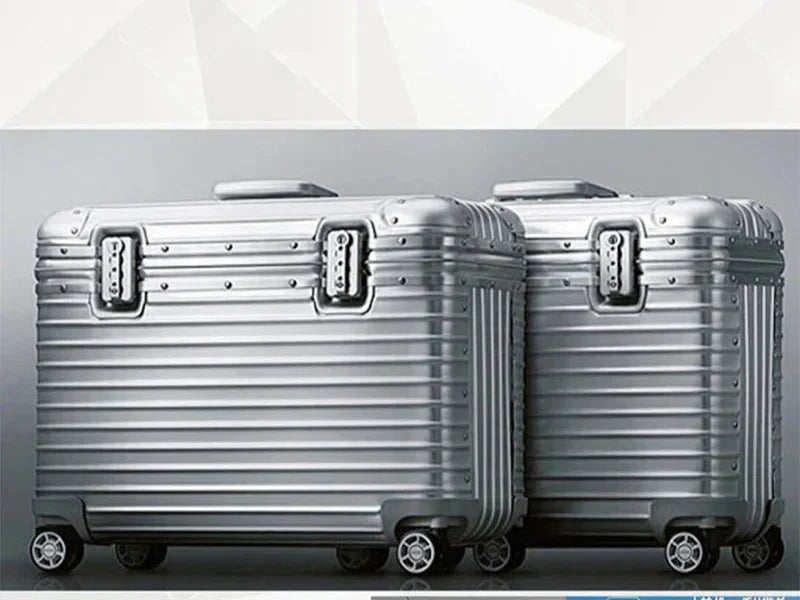 Two silver ribbed cases side by side against a grey studio background, showing riveted corners and locks 4