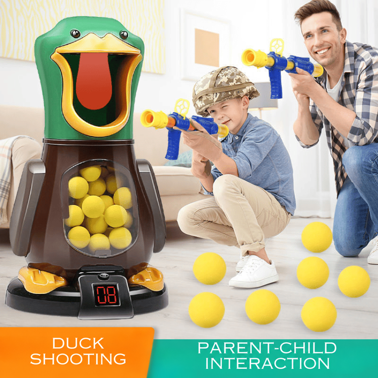 Father and boy in a camouflage helmet aim launchers at the duck target indoors, foam balls scattered nearby 2