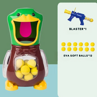 Duck target with bow tie and clear side wings, beside one launcher and twelve foam balls 7