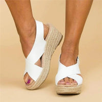 White wedges worn by a model, one foot angled to show the braided rope platform 11