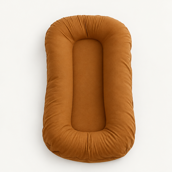 Empty rust-orange lounger with a raised padded border and flat centre, seen from above 9