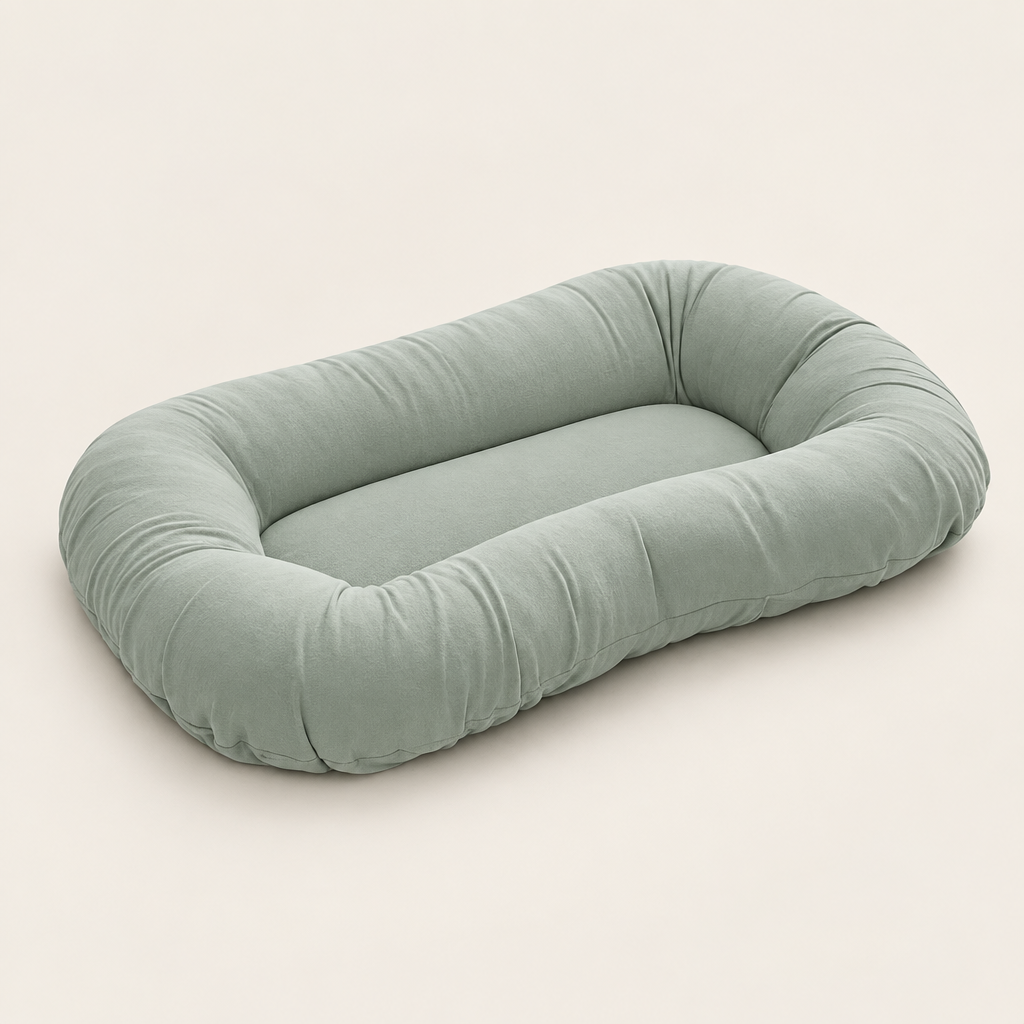 Empty sage green support pillow with raised sides, shown at an angle on a plain background 8