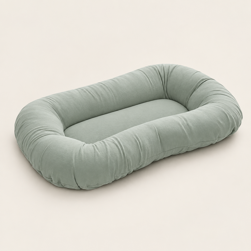 Empty sage green support pillow with raised sides, shown at an angle on a plain background 8