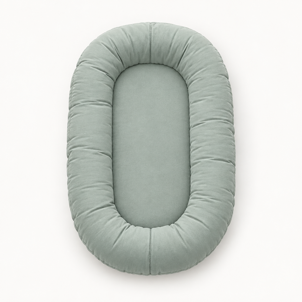 Empty sage-green oval lounger with a plump padded rim, seen from above 8