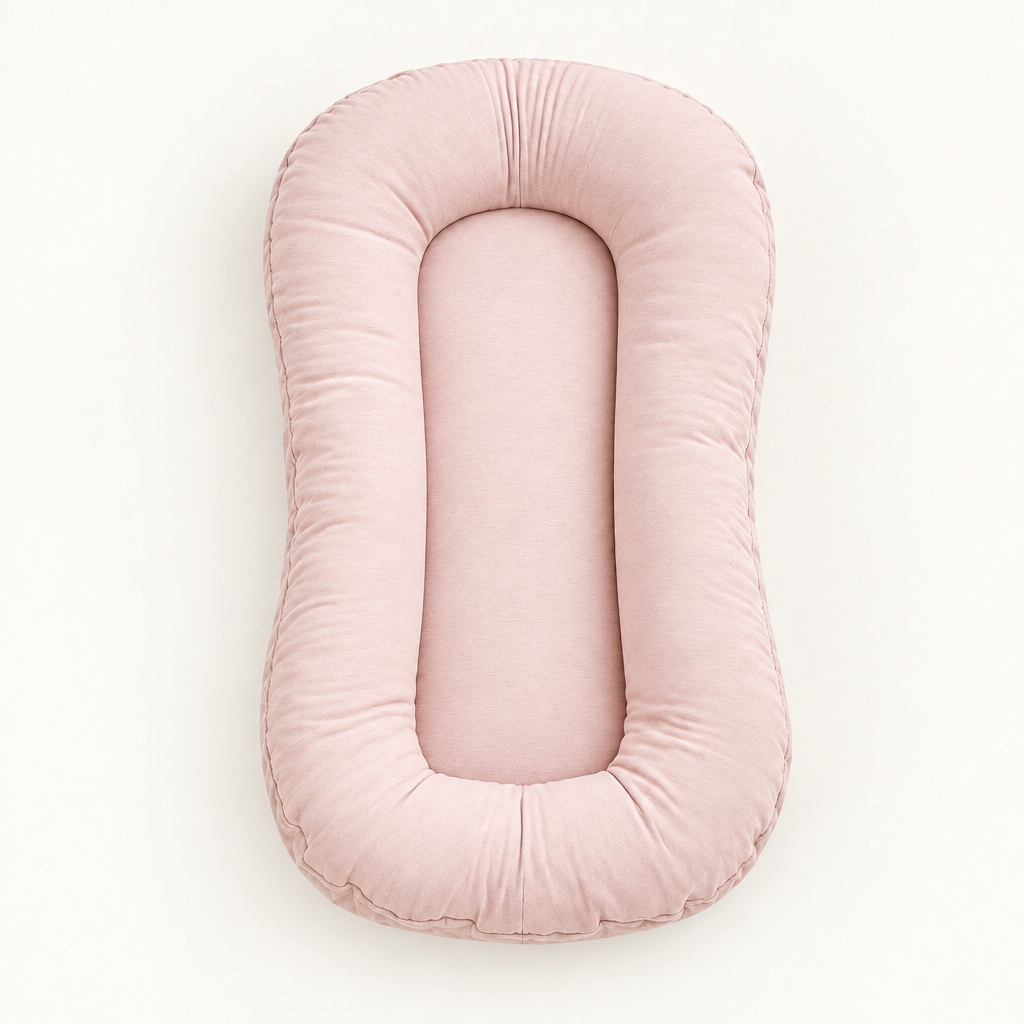 Empty soft pink lounger with a plump padded rim and smooth centre, seen from above 10