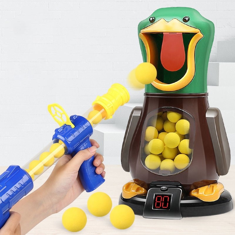 Hand holding a blaster fires a yellow foam ball into the open beak of the duck target 3