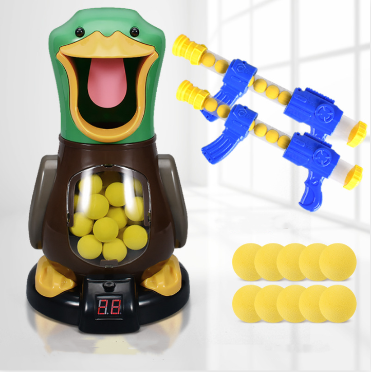 Duck target with two blasters and ten loose yellow foam balls on a plain studio background 6