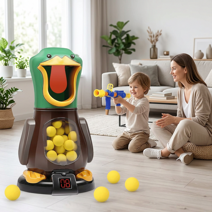 Boy aims a blue and yellow foam-ball blaster at the green duck target while his smiling mother watches 1