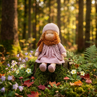 Doll in a knitted lilac cardigan, orange scarf and polka-dot dress sitting on a mossy stump among woodland flowers 1
