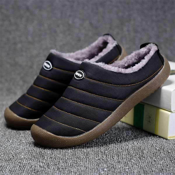 Pair of black quilted fleece-lined slippers with brown soles, one leaning on books 8