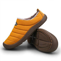 Mustard slipper side view alongside another turned over to show the treaded brown sole 12