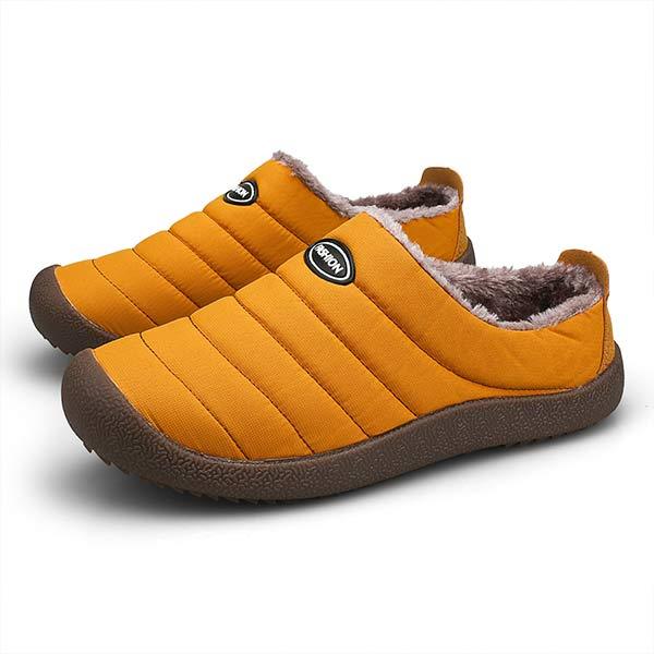 Pair of mustard yellow quilted slippers with fleece lining on a plain white background 11