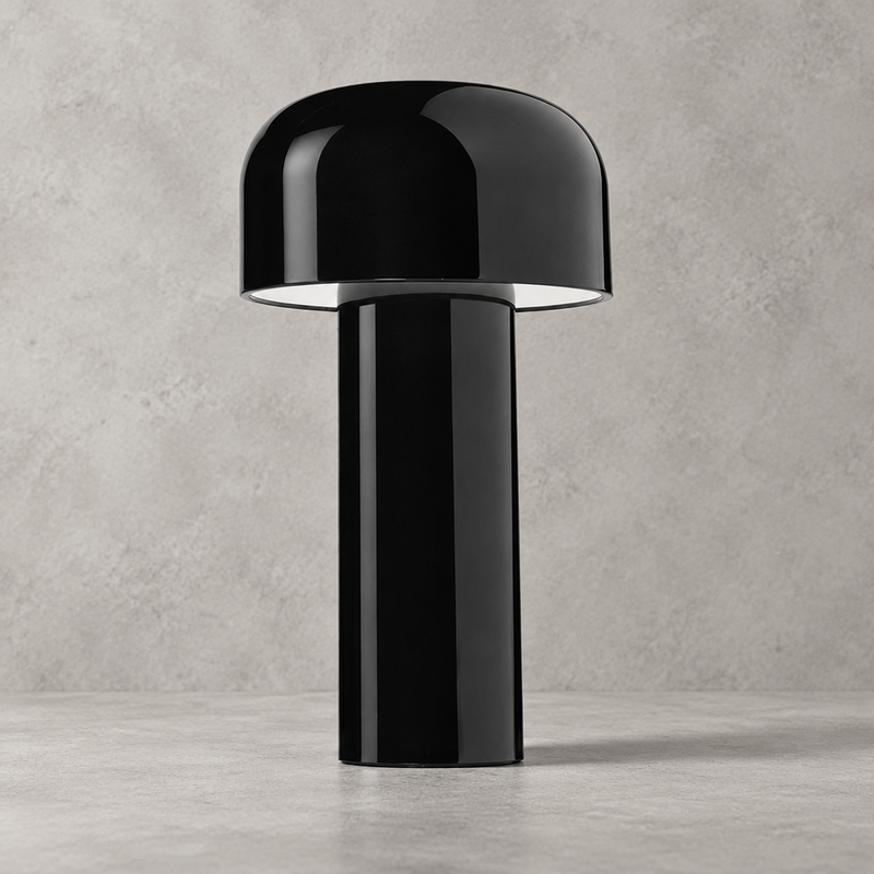 Glossy black lamp with domed shade and white underside glow, against a grey wall 33