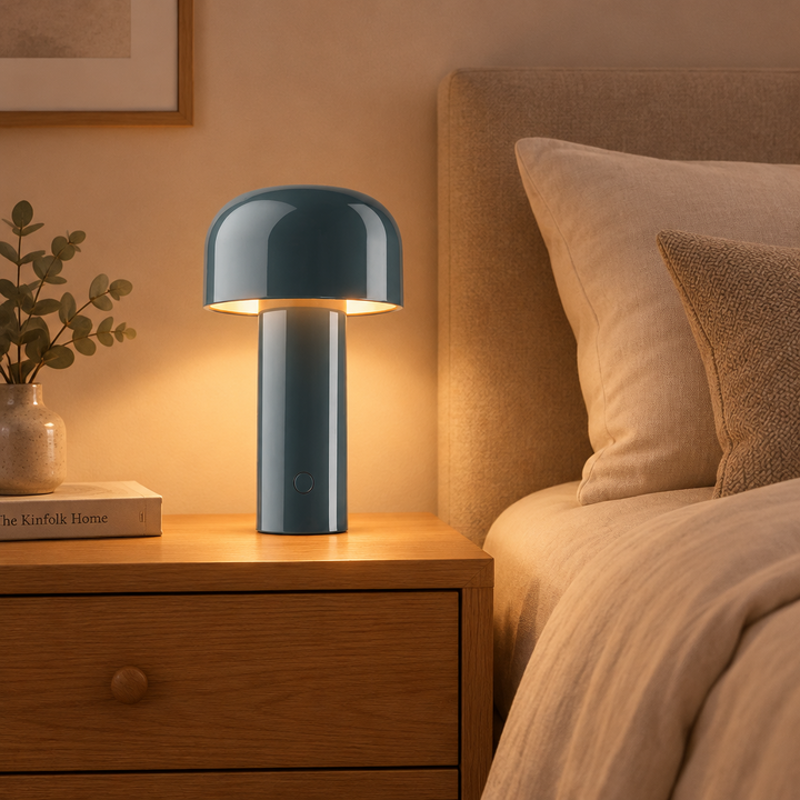 Glowing slate-blue mushroom lamp on an oak bedside table beside a bed and eucalyptus 1