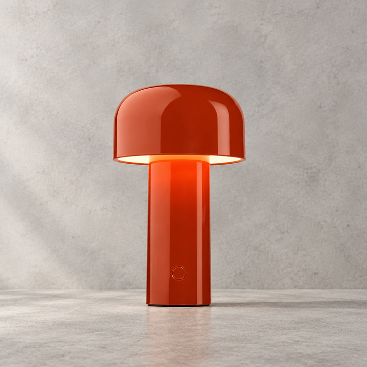 Glossy red-orange lamp lit against a grey stone-effect wall, touch button visible on the stem 29