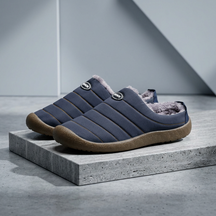 Pair of navy blue slippers with fleece interior displayed on a concrete block 18