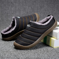 Black quilted slippers with soft grey fleece lining, one tilted against books on grey carpet 9