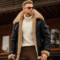 Model wearing the black jacket open over a cream knit, tan fleece collar and cuffs visible 2