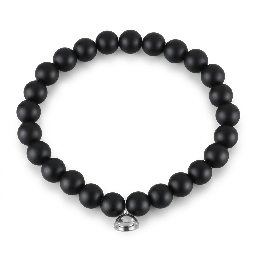 Studio shot of the matte black bead bracelet with its silver magnetic charm on plain white 5