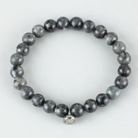 Flat lay of a bracelet of dark grey speckled round beads with a small silver clasp 4