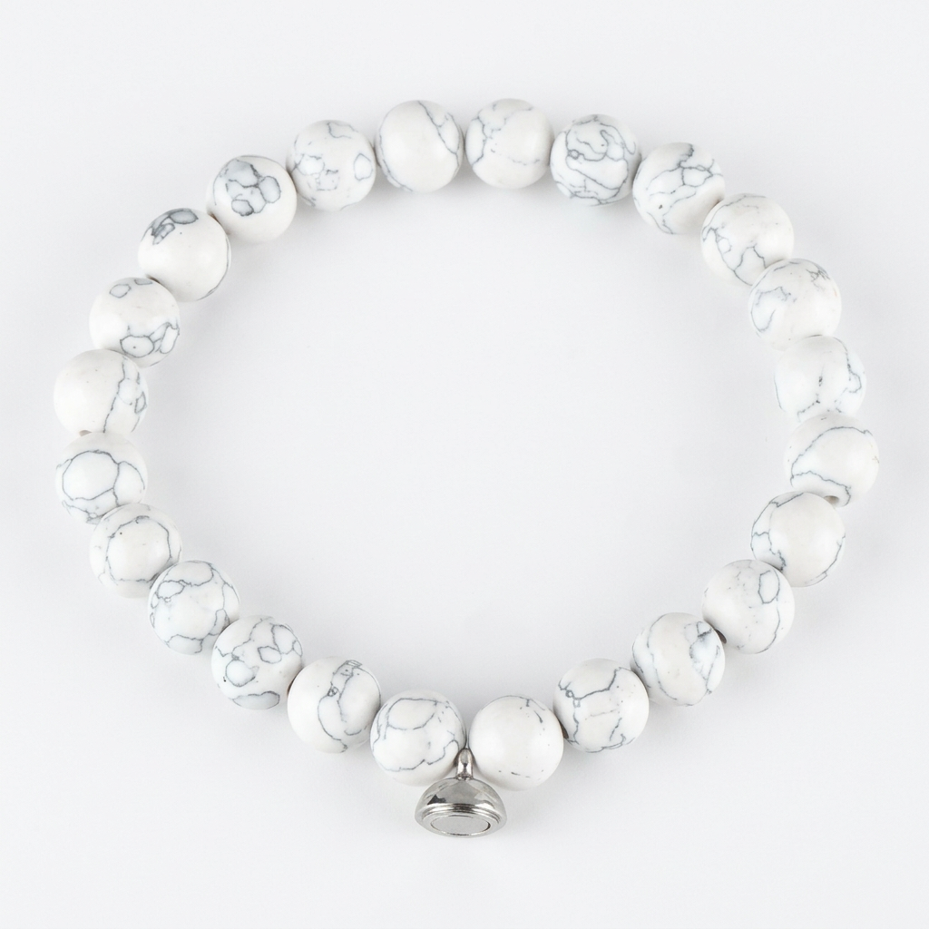 Studio shot of the white marbled bead bracelet with grey veining and a silver magnetic charm 6