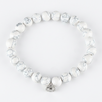 Studio shot of the white marbled bead bracelet with grey veining and a silver magnetic charm 6