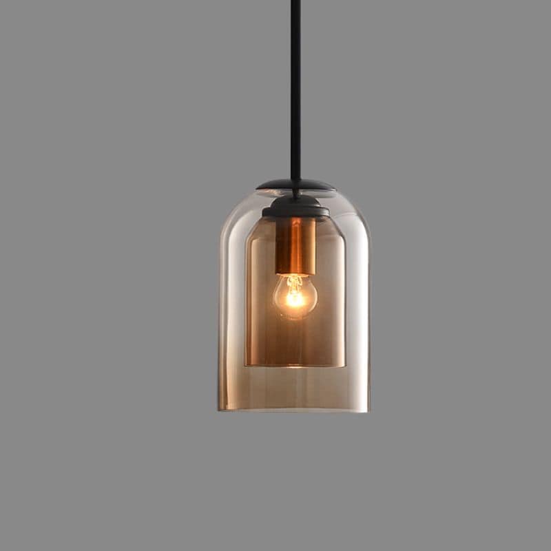 Amber double-glass pendant on a black rod with a copper-toned bulb holder, lit, against a plain grey background 11