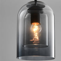 Close-up of the smoke grey pendant showing the inner glass shade, black holder and lit filament bulb 8