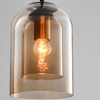 Close-up of the amber double glass shades showing a copper-toned bulb holder and lit bulb 9