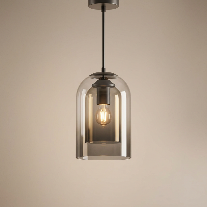 Smoke grey layered glass pendant with a lit filament bulb, photographed against a soft beige backdrop 13
