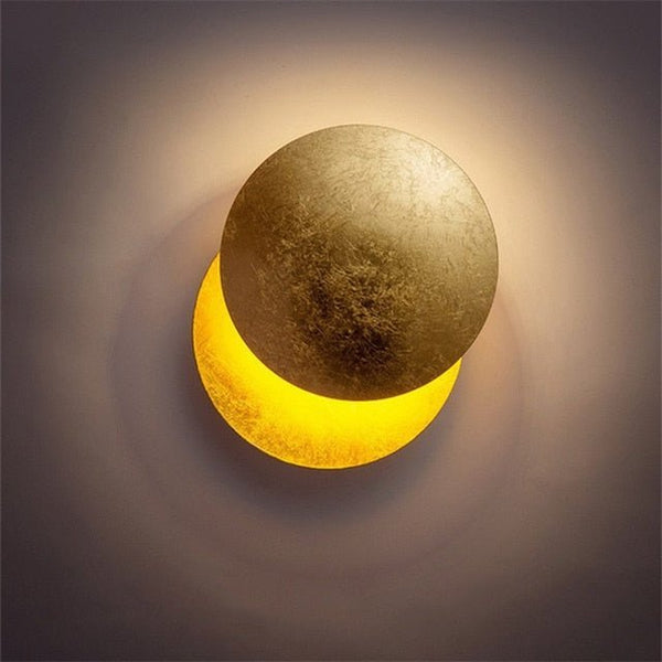 Close-up of the lamp with its front disc turned upward, showing the warm glowing lower disc 5