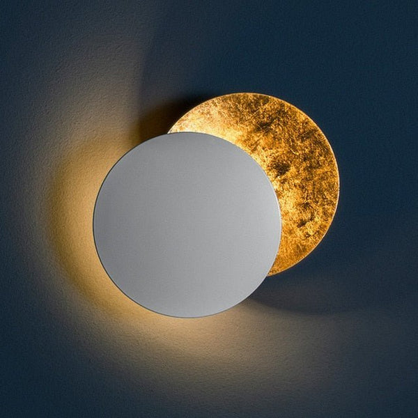 White-fronted moon lamp on a dark blue wall, with a textured gold disc glowing behind 9