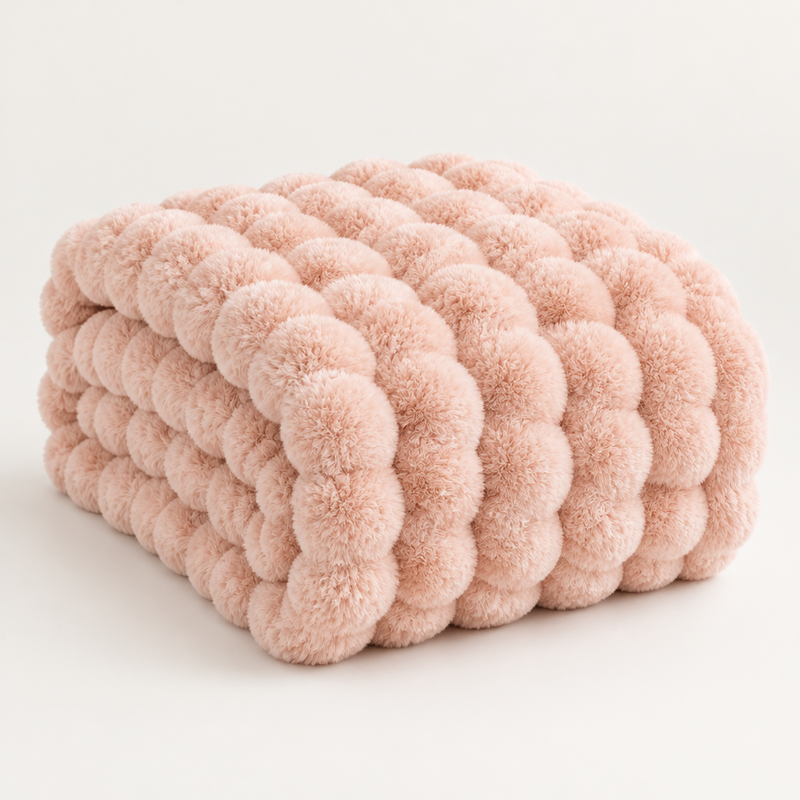 Pale pink plush blanket folded to show its thick rounded bubble texture on a light background 15