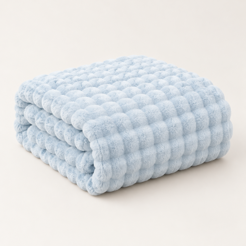 Pale blue plush blanket folded in a neat stack on a plain light background 12