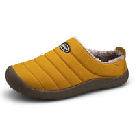 Single mustard yellow slipper in three-quarter view on white, showing fleece lining and rounded brown sole 13