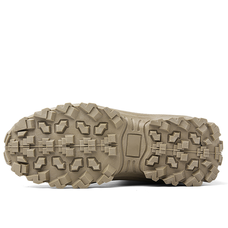 Underside of a sand-coloured boot showing the deep, blocky lugs of the outsole 13