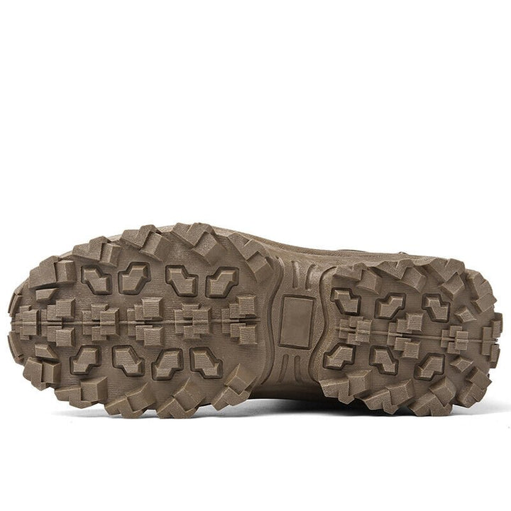 Underside of a brown boot showing the deep, blocky lugs of the outsole 18