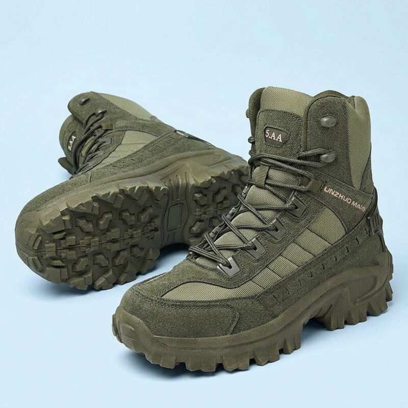 Pair of olive green lace-up boots on a pale blue background, one resting on its side showing the sole 25