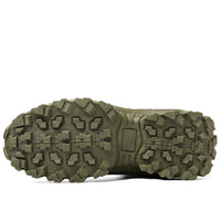 Underside of an olive green boot showing the deep, chunky lugged tread pattern of the sole 22