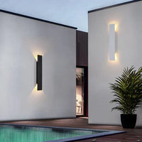 Black and white versions of the wall light on white walls beside a swimming pool 4