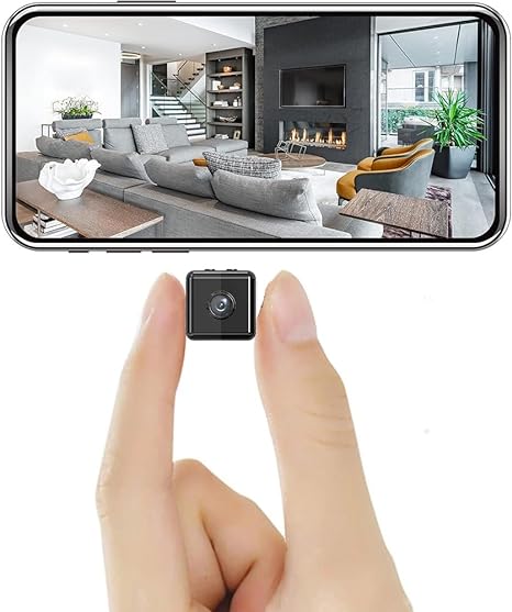 Small black camera pinched between two fingers beneath a phone screen showing a live view of a living room 2