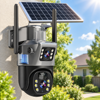Dual-lens camera with solar panel mounted on a house wall in bright sunshine with garden behind 14