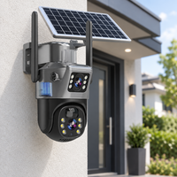 Dual-lens solar camera with two antennas mounted on a rendered house wall beside a front door 1