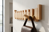 Light beech-coloured hanger with a brass hinge and a dark brown leather satchel hanging from a hook 13